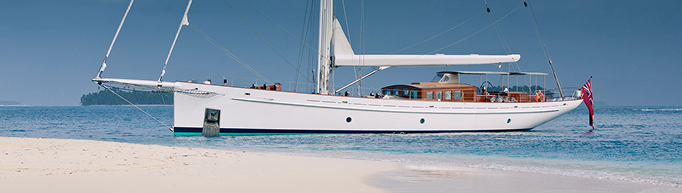 Classic sailing yacht by a tropical beach